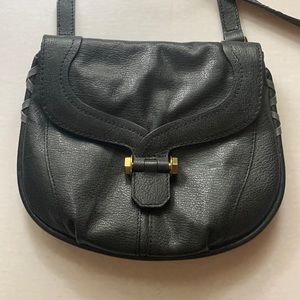 Black leather orYANY crossbody bag with bronze hardware